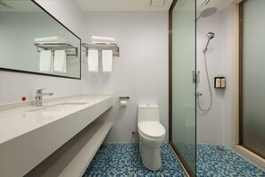 A bathroom with a white sink, mirror, toilet, and shower. - Theme Hotel of No. 8 Mansion (Liuyang Shop) (Liuyang)