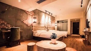 A modern bedroom with a bed, a desk, and a chair.