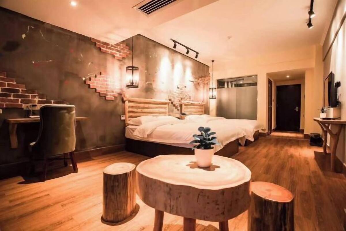 A modern bedroom with a bed, a desk, and a chair.