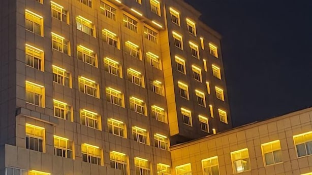 A multi-story hotel with uniformly lit windows and a modern architectural design.