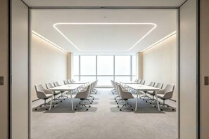 A conference room with a long table, chairs, and a modern ceiling design. - Xundian Fengyi Hotel (Tangdian Passenger Transport Terminal) (Xundian)