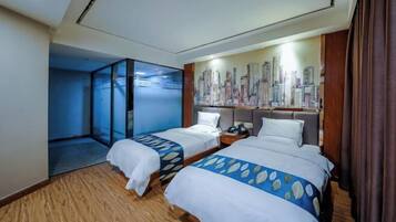 A hotel room with two beds, a cityscape mural, and a glass partition.