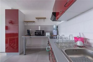 Enjoy cooking in this kitchen with a central island, microwave, coffee maker, and water dispenser.