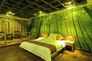A room with a bed, nightstands, a wooden chair, and a staircase.