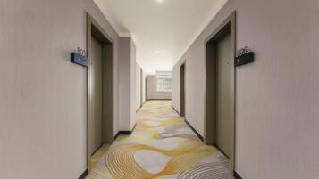 A hotel hallway with doors numbered 806 and 807, leading to rooms.