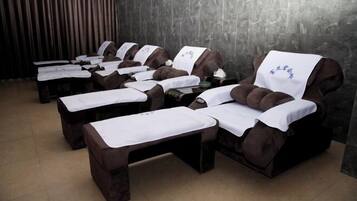 Relax in a serene space with a massage table and comfortable headrest.