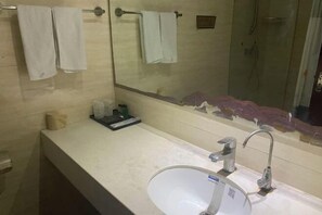 A bathroom with a white sink, a mirror, and a shower area. - Hancun River Villa (Beijing)