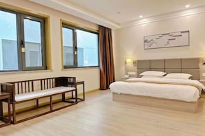 A hotel room with a bed, a bench, and large windows. - Hancun River Villa (Beijing)