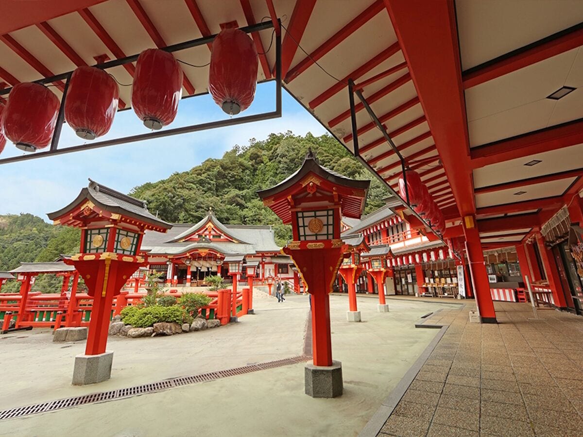 Um templo japonês tradicional com lanternas vermelhas e telhado de telhas.