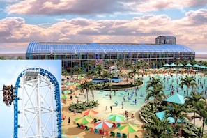 Um grande resort com estrutura de vidro, área de piscina e montanha-russa.