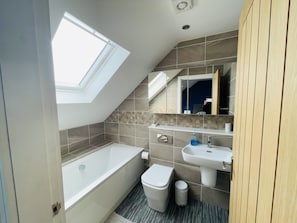 Bathtub, hair dryer, towels, soap