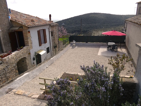 Relax in a serene courtyard surrounded by traditional stone buildings and lush greenery.