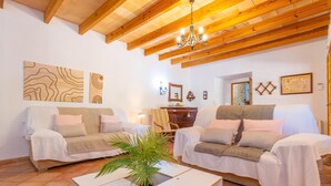 A living room with two sofas, a coffee table, and a chandelier. - SON SEGUÍ - Villa with private pool in Alaró with free WiFi (Alaro)