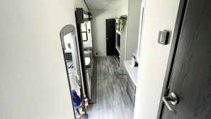 A modern interior with a staircase leading to a kitchen area. - Johnny Love, Modern and Bright Paradise RV (San Diego)