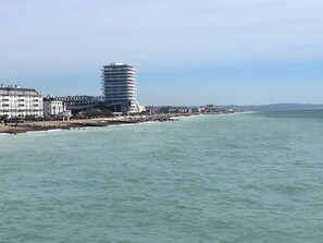 A coastal hotel with a modern design, featuring a prominent tower and a beachfront location. - Worthing Beach 180 - 2 bed Seafront With Parking (Worthing)
