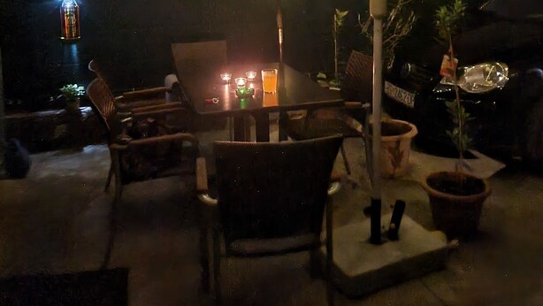 An outdoor patio area with a table, chairs, potted plants, and string lights. - Beautiful 1-bed Apartment in Sveta Nedelja (Sveta Nedelja)