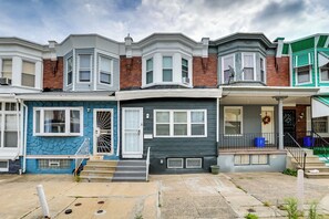 Townhouses with unique architectural styles and features, each with a front porch and bay window.