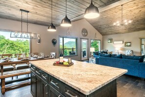 Relax in a spacious room with a central island, comfortable seating area, and stunning views of the surrounding landscape.