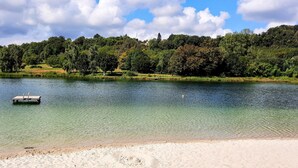 A serene lake with a dock and a sandy beach. - Peace & tranquillity in the heart of the Dordogne (Lempzours)