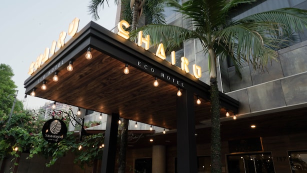The exterior of the ECO HOTEL with illuminated signage and a wooden canopy. - Chairú Eco Hotel (Santa Cruz)