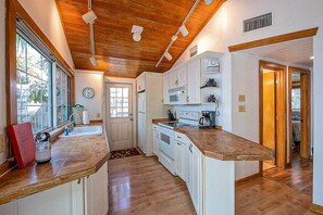 A kitchen with wooden cabinets, a microwave, and a coffee maker.