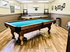 Enjoy a game of pool in this room with a pool table and comfortable seating.