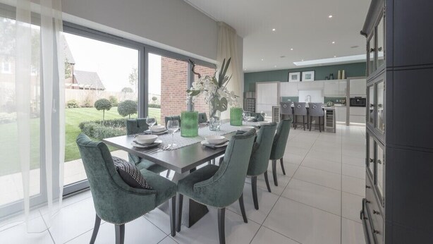 A modern kitchen with a dining area.