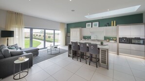 A modern apartment with a living room, kitchen, and dining area.
