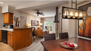 A spacious kitchen with wooden cabinets, a dining area with a large table, and a ceiling fan. - Large 1-Bdrm Villa in lovely Avon, CO- available wk of July 22-29 (Avon)