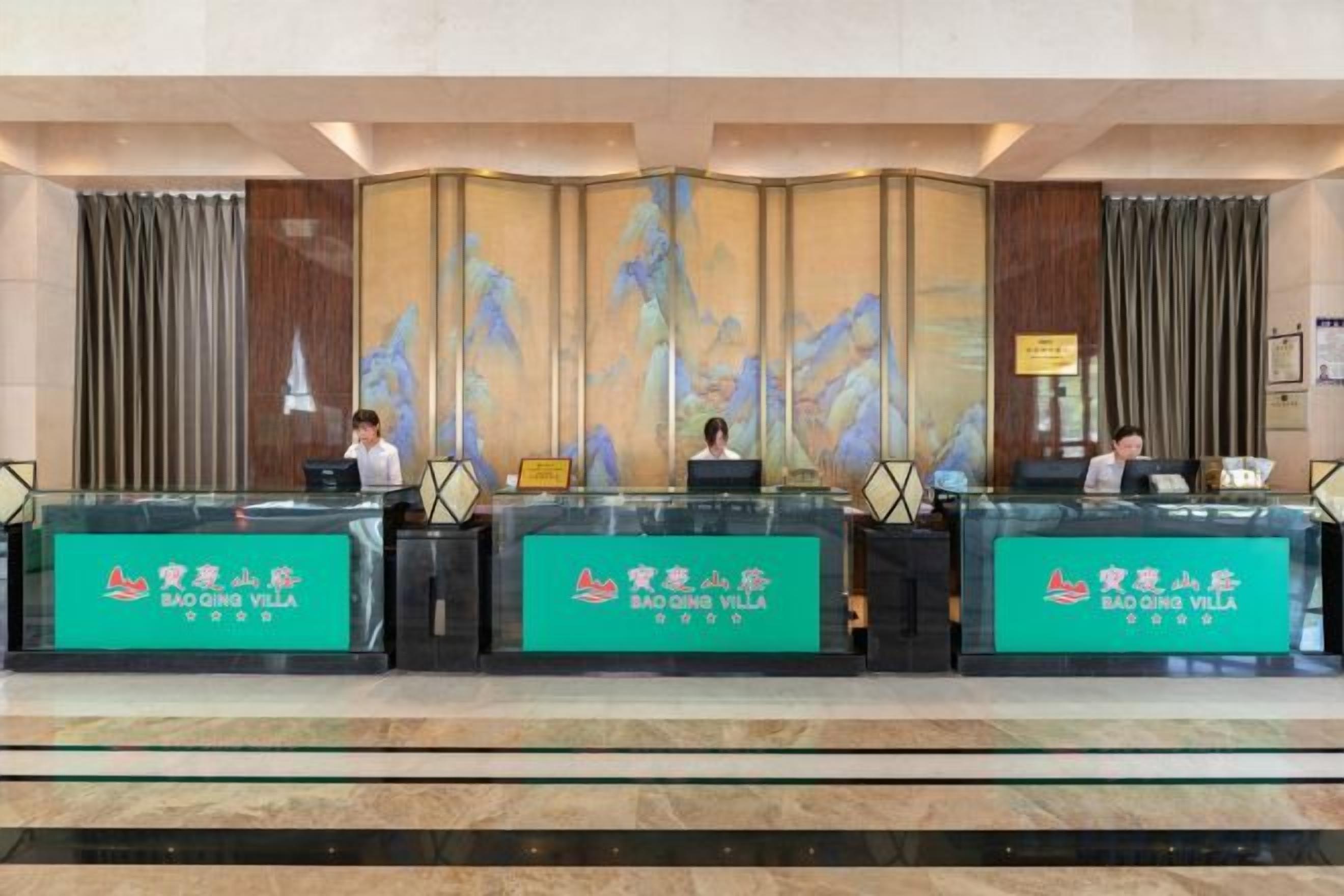A reception desk with three counters, each labeled 'Bao Ding Villa.'