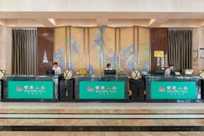 A reception desk with three counters, each labeled 'Bao Ding Villa.' - Baoqing Villa (Shaoyang)