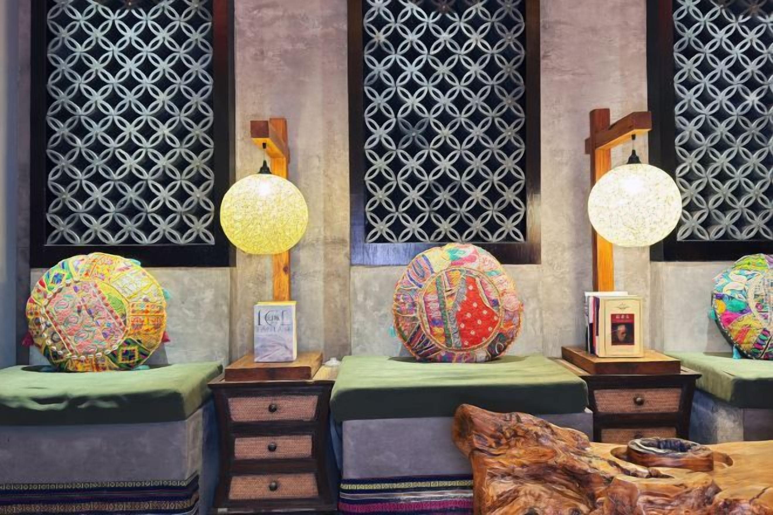 A room with four bedside tables, each with a lamp and a decorative globe.