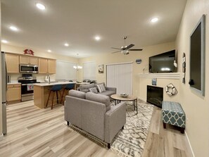 Relax in a comfortable seating area with a sofa and armchairs, enjoy casual meals at the bar counter, or cook in the well-equipped kitchen.