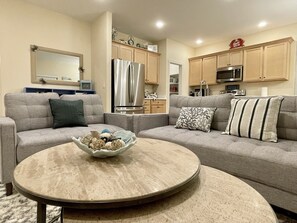 Relax in this stylish living room with a comfortable sofa and coffee table, perfect for unwinding.