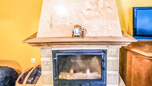A fireplace with a decorative mantel and a television mounted on the wall above it. - Awesome home in Kamionki Male (Kamionki Male)