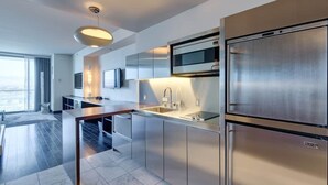 A modern kitchen with stainless steel appliances, a built-in microwave, and a large refrigerator.