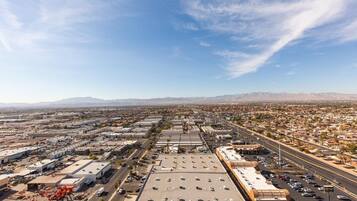 An aerial view of a commercial area with multiple buildings, roads, and a parking lot.