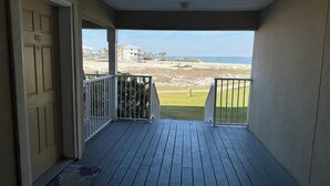 A wooden deck with a view of the beach and ocean. - Beautifully Remodeled Bay Front Condo (Navarre)