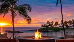 A fire pit with a sunset view, surrounded by lounge chairs. - Deluxe Ocean View Studio Marriott Ko Olina Beach Club!  6/25/2027 - 7/2/2027. (Kapolei)