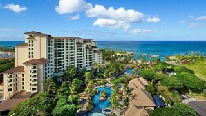 A resort with a large building, a swimming pool, and a view of the ocean. - Deluxe Ocean View Studio Marriott Ko Olina Beach Club!  6/25/2027 - 7/2/2027. (Kapolei)