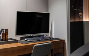 A modern office desk with a large monitor, keyboard, and mouse. - Wonju Central Hotel (Wonju)