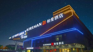 A hotel named Borrman with illuminated signage and a modern facade.
