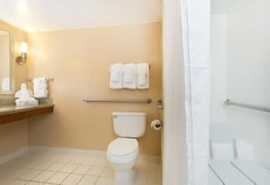 A bathroom with a toilet, a towel rack, and a shower area. - Best Western Orlando Gateway Hotel (Orlando)