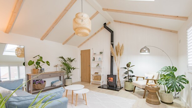 A cozy living room with a sofa, a small table, a fireplace, and various plants. - The perfect retreat for couples wanting to enjoy Deal (Deal)
