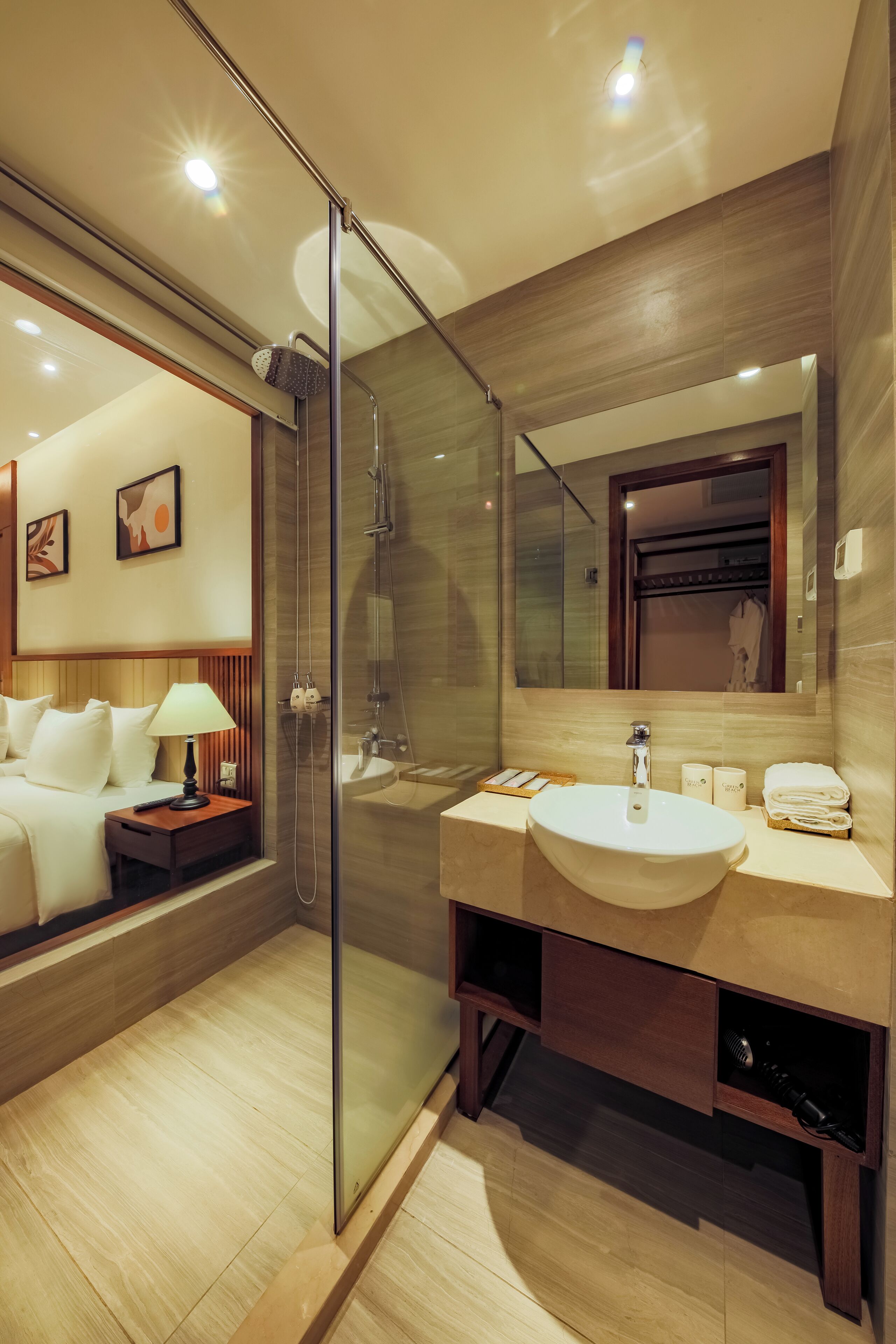 A modern bathroom with a glass-enclosed shower, a large sink, and a mirror above it.