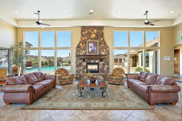 Relax in the inviting lobby with a stone fireplace, comfortable seating, and a beautiful view.