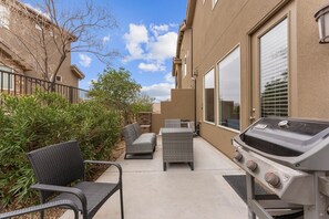 Relax and dine al fresco with a barbecue grill and comfortable seating for two.