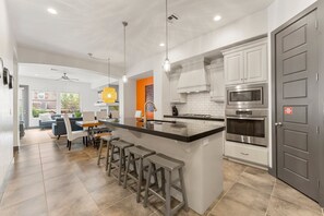 Enjoy cooking in this well-equipped kitchen with a large island and appliances.