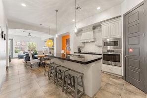 Enjoy cooking in this well-equipped kitchen with a large island and appliances.
