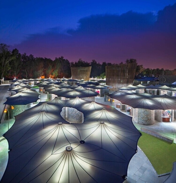 A large outdoor area with numerous umbrella-shaped structures, likely serving as seating or shelter.